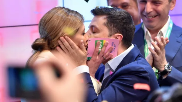 Ukrainian comedian and presidential candidate Volodymyr Zelensky kisses his wife Olena after the announcement of the first exit poll results in the second round of Ukraine's presidential election at his campaign headquarters in Kiev on April 21, 2019.  Sergei GAPON / AFP
