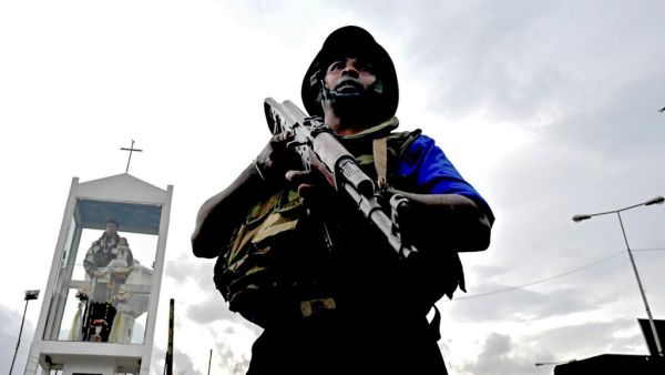 A Sri Lankan soldier stands guard near a car explosion after the police tried to defuse a bomb near St. Anthony's Shrine in Colombo  (AFP)