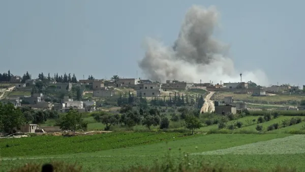 Smoke billows after reported shelling on the Syrian village (AFP)
