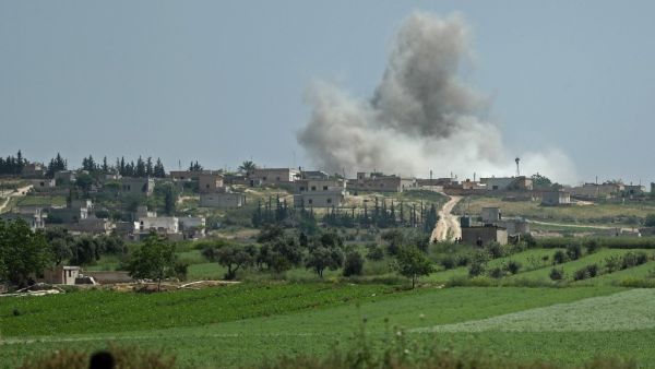 Smoke billows after reported shelling on the Syrian village (AFP)