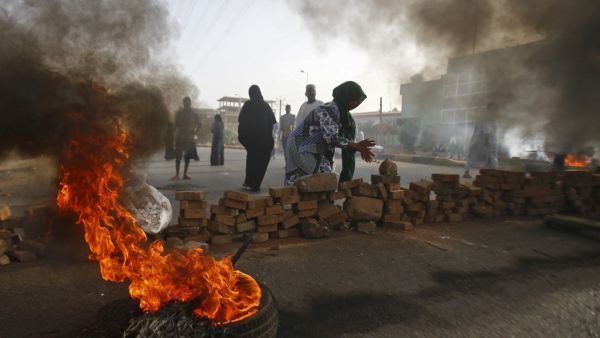 Sudanese protesters close Street 60 with burning tyres and pavers as military forces tried to disperse a sit-in outside Khartoum's army headquarters  (AFP)