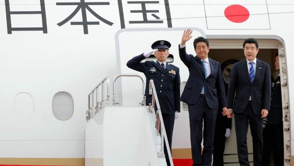 Japan's Prime Minister Shinzo Abe (C) waves to well-wishers upon his departure at Tokyo's Haneda Airport on June 12, 2019. Abe left for a two-day visit to Iran.  JIJI PRESS / AFP