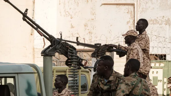 A member of Sudan's Rapid Support Forces (RSF) paramilitaries mans a machine gun turret while on guard outside the offices of the anti-corruption prosecution in the capital Khartoum (AFP)
