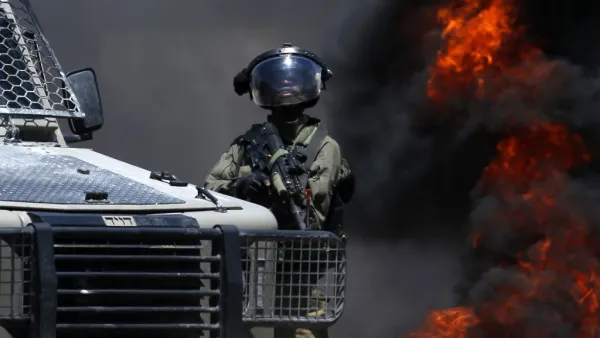 A member of the Israeli forces looks on during clashes with Palestinian protesters (AFP)