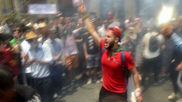 Algerian demonstrators shout slogans as they take part in a protest in the capital Algiers (AFP)