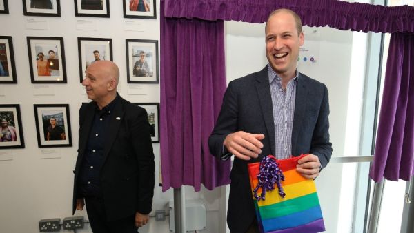 Britain's Prince William, Duke of Cambridge, reacts to receiving a gift bag from trust chief executive officer Tim Sigsworth during a visit to the Albert Kennedy Trust in London to learn about the issue of LGBTQ youth homelessness in London on June 26, 2019.  Jonathan Brady / POOL / AFP