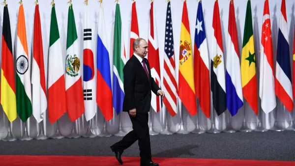 Russia's President Vladimir Putin arrives for the family photo during the G20 Osaka Summit in Osaka on June 28, 2019.  Brendan Smialowski / AFP