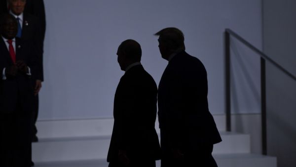 US President Donald Trump (R) walks with Russia's President Vladimir Putin before taking a family photo at the G20 Summit in Osaka on June 28, 2019.  Brendan Smialowski / AFP