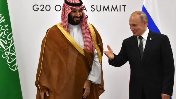 Russia's President Vladimir Putin (R) gestures toward Saudi Arabia's Crown Prince Mohammed bin Salman during a meeting on the sidelines of the G20 Summit in Osaka on June 29, 2019.  Yuri KADOBNOV / POOL / AFP