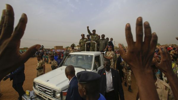 General Abdel Fattah al-Burhan, the head of Sudan's ruling military council, greets his supporters upon his arrival to a rally in Khartoum's twin city of Omdurman (AFP)