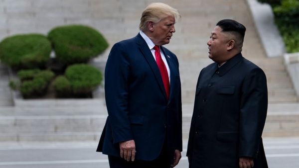 US President Donald Trump and North Korea's leader Kim Jong-un stand on North Korean soil while walking to South Korea in the Demilitarized Zone(DMZ) on June 30, 2019, in Panmunjom, Korea.  Brendan Smialowski / AFP