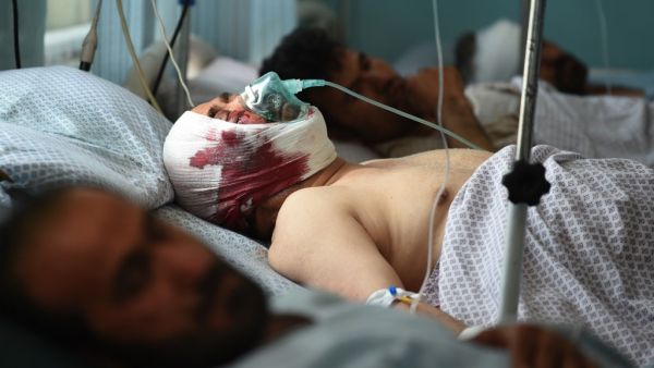 Wounded Afghan men receive treatment at the Wazir Akbar Khan hospital following a car bomb attack in Kabul (AFP)