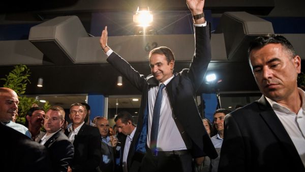 Greece's newly elected Prime Minister and leader of conservative New Democracy party Kyriakos Mitsotakis, waves at his supporters outside the party's headquarters after the official results of the elections, in Athens  (AFP)