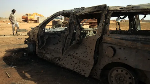 Damaged car at the site of a car bomb attack that targeted servicemen during the funeral of an ex-army commander in the Libyan city of Benghaz (AFP)