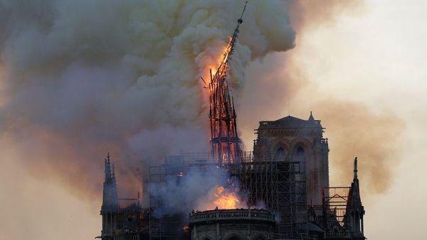 Onlookers cried out in anguish as the spire of the cathedral toppled in the inferno which swept ferociously over the roof of Notre Dame on Monday evening (AFP)