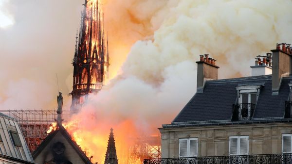 Smoke billows as fire engulfs the spire of Notre Dame Cathedral in Paris. (AFP)