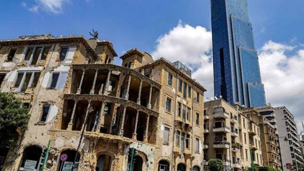 One of Beirut 's iconic landmarks "Sama Beirut" (Beirut Sky) stands tall behind "Beit Beirut" (the house of Beirut) (Twitter)