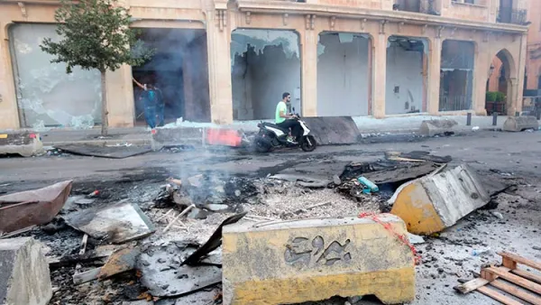 A Lebanese motorist drives past debris at Riad Al Solh Square in the centre of the capital Beirut. Anwar Amro/AFP
