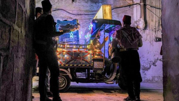 In Pictures: Volunteers and a 'Musaharati' Deliver Pre-Dawn Meals in Syria