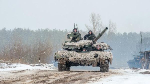 Ukrainian Military Forces servicemen of the 92nd mechanized brigade use tanks, self-propelled guns and other armored vehicles to conduct live-fire exercises near the town of Chuguev, in Kharkiv region, on February 10, 2022. Russia's deployment for a military exercise in Belarus and on the borders of Ukraine marks a "dangerous moment" for European security, NATO's chief said on February 10, 2022. (Photo by Sergey BOBOK / AFP) US Officials: Russia Could Invade Ukraine Any Day Now