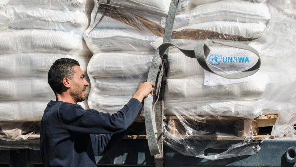 A Palestinian worker checks a truck carrying United Nations Relief and Work Agency (UNRWA) aid supplies that arrived through the Kerem Shalom crossing in the southern Gaza Strip city of Rafah on May 12, 2019. Israel reopened its crossings with the blockaded Gaza Strip after closing them during a deadly escalation earlier this month, an official said, as a fragile truce held.