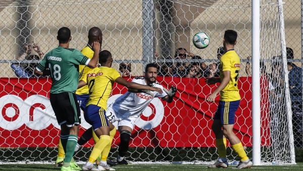 Khadamat Rafah Club's goalkeeper leaps to save the ball during the during the first leg match of the Palestine Cup final between Khadamat Rafah Club and Balata Sports Centre in Rafah in the southern Gaza Strip on June 30, 2019.