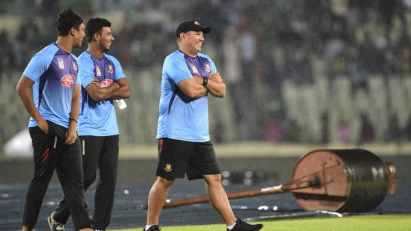 Bangladesh cricket coach Russell Domingo (R), Mosaddek Hossain (C) and Mohammad Saifuddin walk over the field