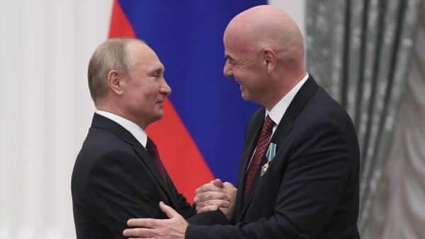 Russian President Vladimir Putin (L) awards the "Order of Friendship" to FIFA President Gianni Infantino during a ceremony at the Kremlin in Moscow