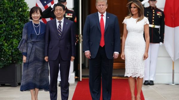 US President Donald Trump and First Lady Melania Trump greet Japan's Prime Minister Shinzo Abe and his wife Akie Abe at the South Portico of the White House as they arrive for dinner in Washington, DC on April 26, 2019. (MANDEL NGAN / AFP)