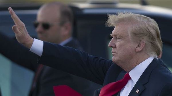 US President Donald Trump waves to supporters after arriving on Air Force One at the Palm Beach International Airport to spend Easter weekend at his Mar-a-Lago resort on April 18, 2019 in West Palm Beach, Florida. (AFP)