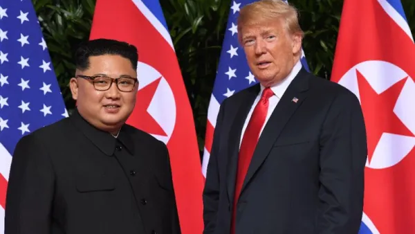 Standing in front of the flags of their two countries, Donald Trump and Kim Jong Un made history in Singapore (AFP Photo/SAUL LOEB)