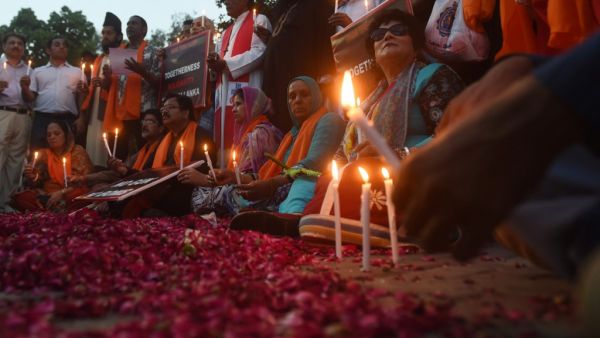 Pakistani civil society activists hold placards and candles to pay tribute to the Sri Lankan blasts victims, during a vigil in Lahore on April 23, 2019. (AFP/ File)