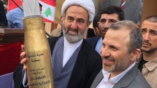 Lebanese FM Jebran Bassil receives a rocket presented to him by Hezbollah. (Twitter)