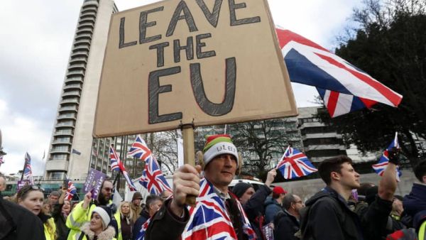 Protesters hold up placards and Union flags as they attend a pro-Brexit demonstration promoted by UKIP in central London. (AFP/ File)