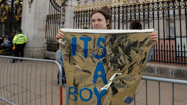 A woman holds a sign that reads "It's a boy" outside the gates of Buckingham Palace in London on May 6, 2019 following the announcement of the birth of a son to Britain's Prince Harry, Duke of Sussex and Meghan, Duchess of Sussex. (AFP/ File)