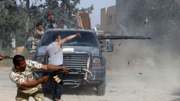 Libyan fighters loyal to the Government of National Accord (GNA) fire their guns during clashes with forces loyal to strongman Khalifa Haftar south of the capital Tripoli's suburb of Ain Zara, on April 20, 2019. (AFP)