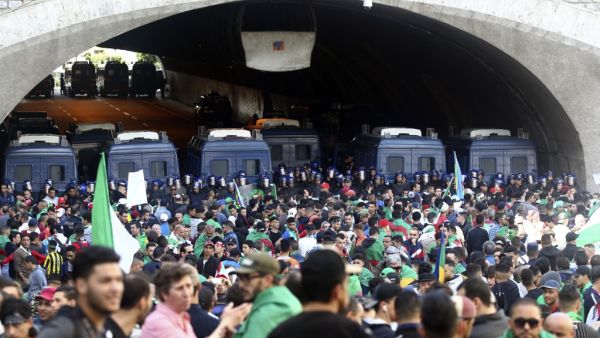 Algerian police stand guard as protesters gather during an anti government demonstration in the capital Algiers on April 26, 2019. (AFP)