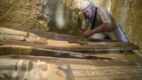An excavation worker works inside a burial shaft at the Giza pyramid plateau, on the southwestern outskirts of the Egyptian capital Cairo, on May 4, 2019, following the discovery of several Old Kingdom tombs and burial shafts. (MAHMOUD KHALED / AFP)
