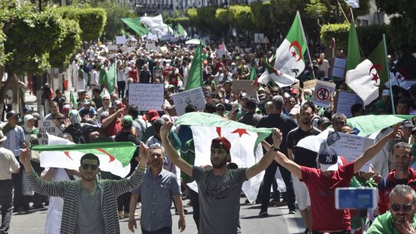 Algerian protesters march with national flags during an anti-government demonstration in the capital Algiers on May 10, 2019. (AFP)