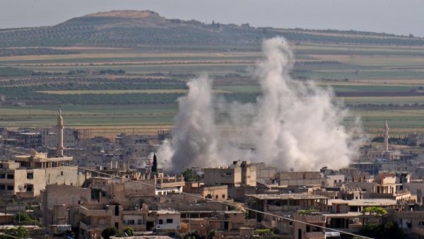 Smoke billows following regime bombardment on the town of Khan Shaykhun in the southern countryside of the rebel-held Idlib province on May 14, 2019. (AFP)