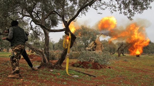 Members of Syria's opposition "National Liberation Front" fire heavy artillery guns at government forces in the village of Talhiyeh near the town Taftanaz in northeastern Idlib province, from another position on February 28, 2020. Abdulwajed HAJ ESTEIFI / AFP