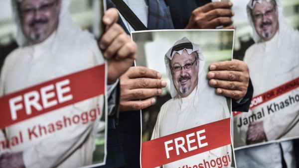 Protestors hold pictures of missing journalist Jamal Khashoggi during a demonstration in front of the Saudi Arabian consulate on October 8, 2018 in Istanbul. (Ozan Kose/AFP via Getty Images)