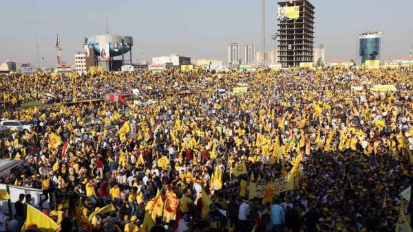 Iraqi Kurds wave flags and a poster of Massud Barzani, leader of the Kurdistan Democratic Party (KDP) ahead of a for a parliamentary election. (AFP)