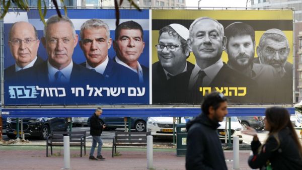 A billboard with Blue and White alliance leaders with Benny Gantz in the centre and another on the right showing Prime Minister Benjamin Netanyahu flanked by right-wing allies. (Jack Guez, AFP)