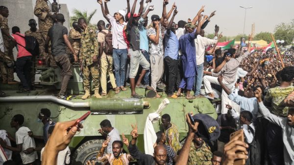 Sudanese anti-regime demonstrators stand on an army armoured military vehicle on April 11, 2019. (AFP/ File Photo)