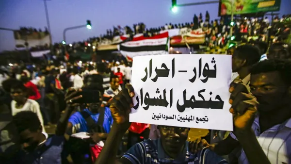 A Sudanese protester holds up a sign reading in Arabic "revolutionaries, free, will continue the course", during a late demonstration demanding a civilian body to lead the transition to democracy. (ASHRAF SHAZLY / AFP)