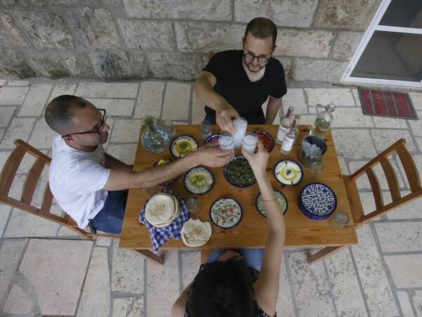 Palestinian distiller Nader Muaddi drinks his handcrafted Arak in the occupied West Bank city of Beit Jala, near Bethlehem, on June 16, 2019. In his basement, distiller Muaddi made fewer than 500 bottles of liquor last year, but it is earning global acclaim and reviving interest in the Palestinian alcohol sector. On the outskirts of the city famed for Jesus's birth, the 35-year-old illustrates the handcrafted way he makes Arak, an anise-flavoured drink popular in the Middle East and similar to Greek Ouzo, F