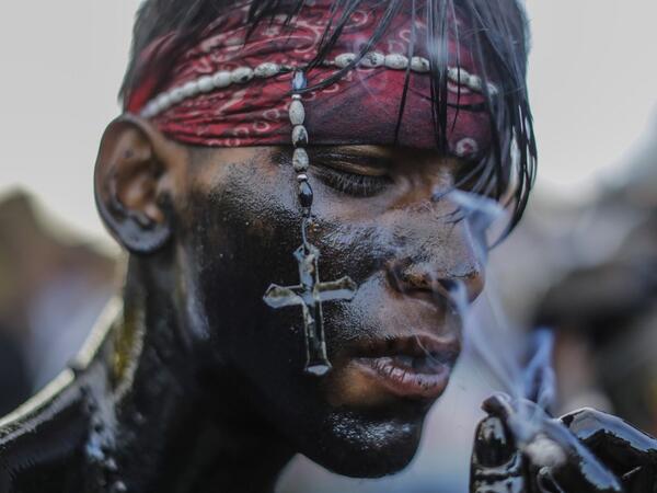 A catholic faithful smeared in burnt oil, takes part in the opening of the ten-day celebration of the Santo Domingo de Guzman festival in Managua, on August 1, 2019.  INTI OCON / AFP