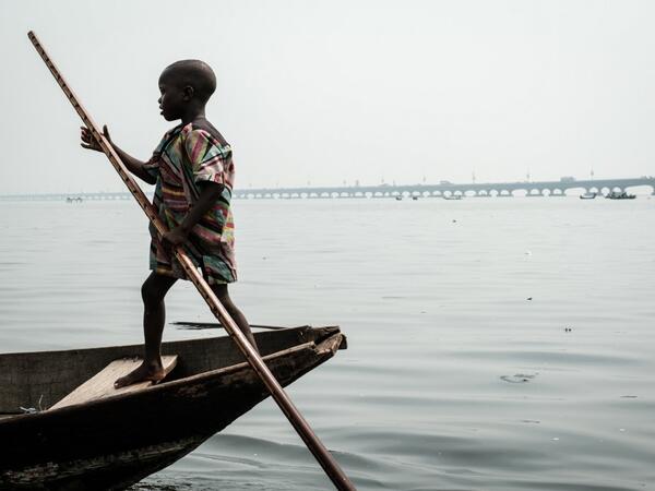 A picture taken on March 2, 2019 shows a boy steering a boat in the Makoko waterfront community in a polluted lagoon in Lagos, Africa’s biggest megalopolis in Nigeria. The sprawling community began in the 19th century as a fishing village for immigrants who settled on the water's edge. As more arrived and land became rare, people started to move out onto the water. Over time, Makoko became a floating realm of perhaps a quarter of a million people, although the real number is anyone's guess. YASUYOSHI CHIBA 