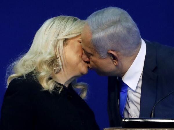 Israeli Prime Minister Benjamin Netanyahu kisses his wife Sara before addressing supporters at the Likud party campaign headquarters in the coastal city of Tel Aviv early on March 3, 2020, after polls officially closed. Netanyahu claimed "a giant victory" in elections on March 3, boasting that his right-wing Likud party had defied "all expectations" in the country's third vote in less than a year. After exit polls by three networks forecast that Likud and its allies were on track to win 59 parliamentary sea
